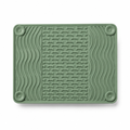 Sage green silicone lick mat with raised grooves on a white background