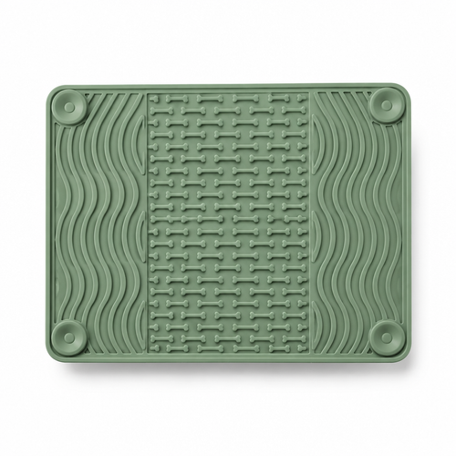 Sage green silicone lick mat with raised grooves on a white background